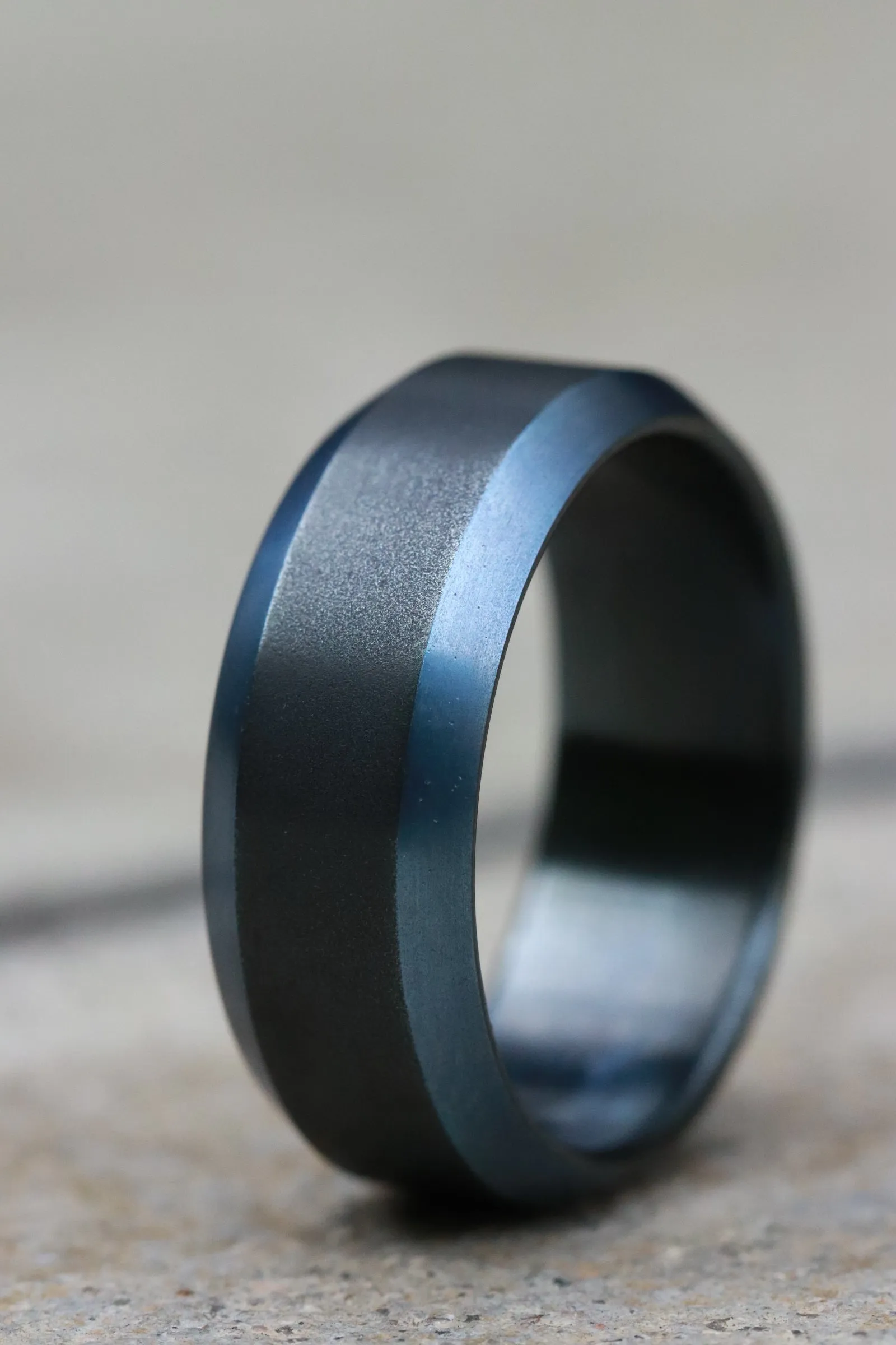 Black titanium ring 8mm wide blue / black chamfered titanium ring