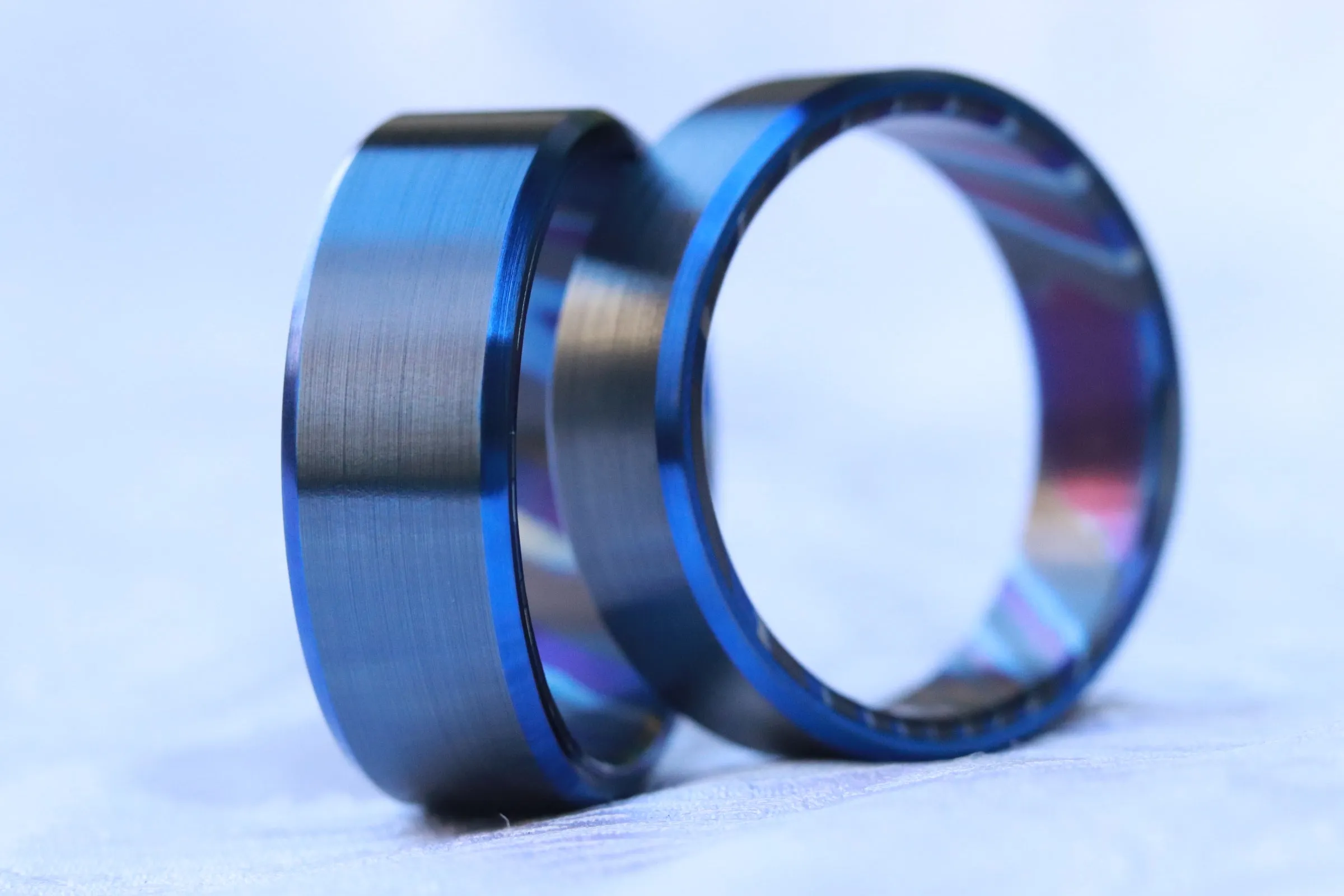 Matching set of two Black & blue titanium ZrTi band black titanium