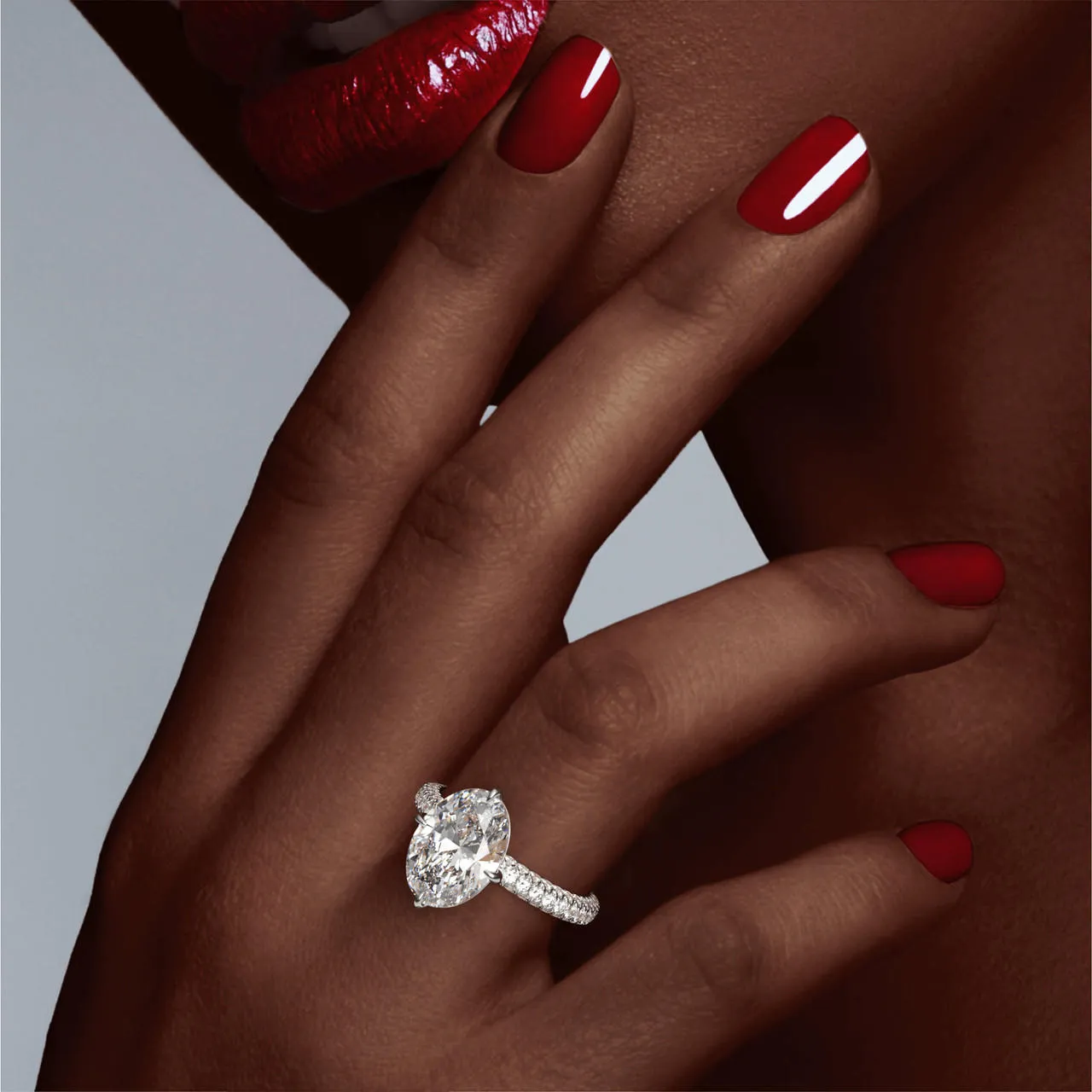 OVAL CUT DIAMOND ENGAGEMENT RING WITH A COMPASS 4 PRONG THREE PHASES TRIPLE PAVE SETTING IN PLATINUM