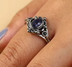 Silver colored adjustable ring w/ purple stone